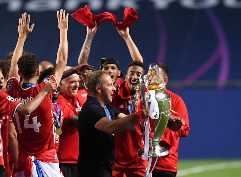 Bayern Munich coach Hansi Flick holds the trophy. Reuters