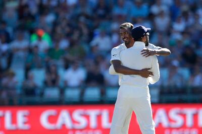 Indian bowler Hardik Pandya (L) celebrates the dismissal of South African batsman Aiden Markram (not in picture) during the second day of the first Test cricket match between South Africa and India at Newlands cricket ground on January 6, 2018 in Cape Town.  / AFP PHOTO / GIANLUIGI GUERCIA