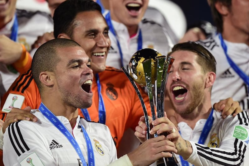 Real Madrid’s defender Sergio Ramos (R), Portuguese defender Pepe (L) and Costa Rican goalkeeper Keylor Navas celebrate after winning the FIFA Club World Cup final football match against San Lorenzo at the Marrakesh stadium in the Moroccan city of Marrakesh on December 20, 2014. Real Madrid defeated San Lorenzo of Argentina 2-0 to win the Club World Cup and secure their fourth trophy of 2014. AFP PHOTO / JAVIER SORIANO