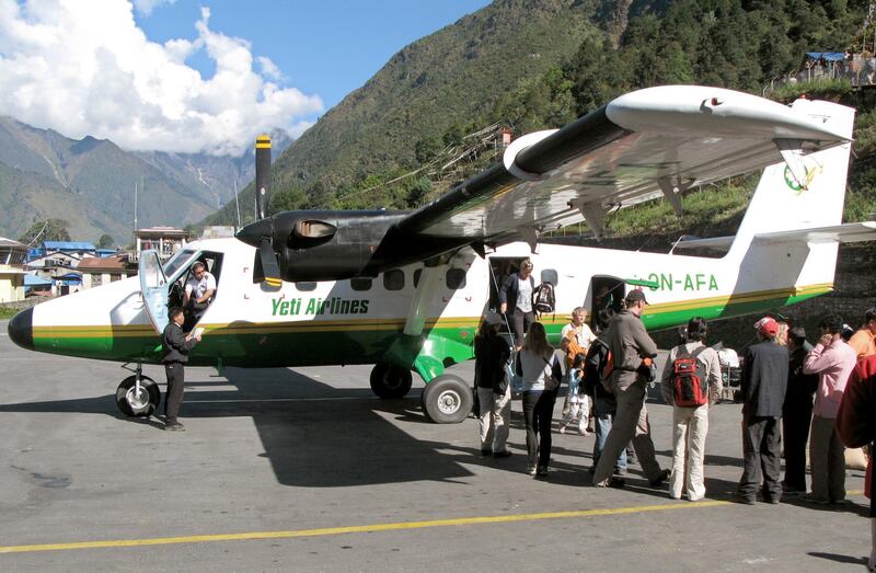 (FILE) - The file picture dated October 2007 shows tourists disembarking an aircraft of the type Twin Otter of Yetio Airlines after its arrival on the runway of the airport Lukla in Nepal. A propeller plane of the same type crashed at the Tenzing-Hillary-Airport in the Himalaya in 3,000 metres height on 08 October 2008. 18 people died in the accident, among them were 12 Germans. The airplane of Yeti Airlines had left the Nepalese capital Kathmandu in the morning of 08 October. Due to its runway between a steep slope on one side and a crag on the other side, the airport Lukla, located 150 kilometres to the north-east, is one of the most dangerous in the world. Photo by: Joern Bender/picture-alliance/dpa/AP Images