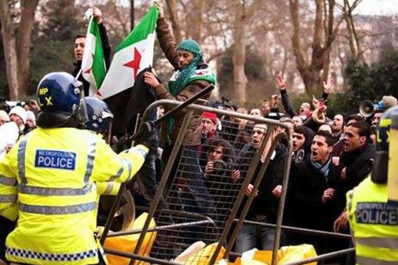 Anti-Syrian government protestors clash with police outside the Syrian Embassy in London in February. Leon Neal / AFP