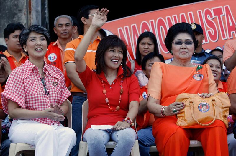 Former Philippine first lady Imelda Marcos (R), running for a congressional seat, is joined by her daughters Imee, running for a gubernatorial election, and Irene (L) during their first day of campaigning at the Paoay town, Ilocos Norte, north of Manila, March 26, 2010. Imelda started campaigning for congressional seats at Ilocos province on Friday. REUTERS/Romeo Ranoco (PHILIPPINES - Tags: POLITICS ELECTIONS)
