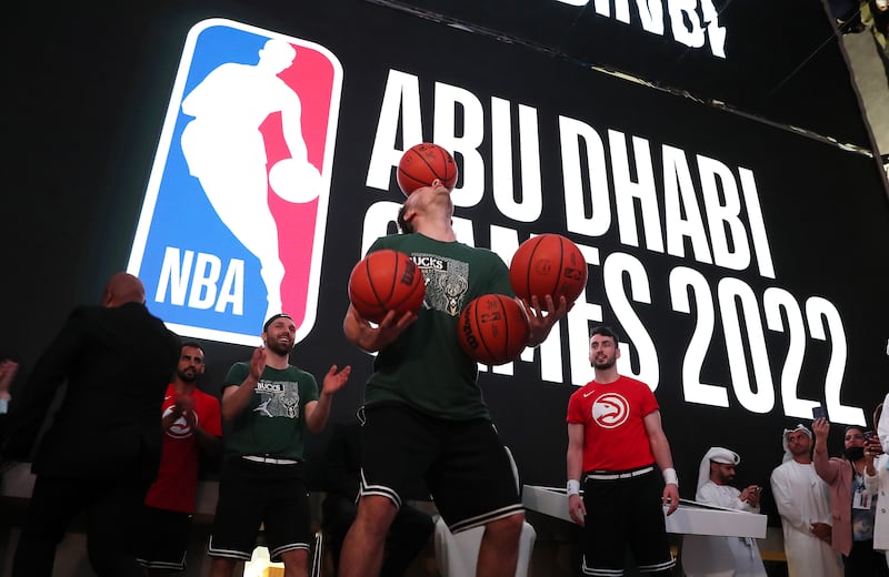 A freestyle performer balances basketballs during the press conference for the NBA Abu Dhabi Games.
