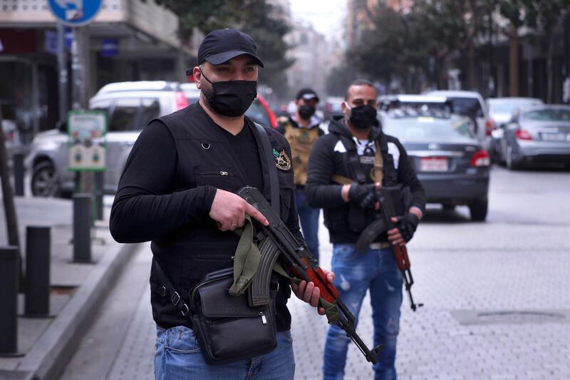 Lebanese intelligence officers deploy on a street to urge people to stay home unless they have an emergency, in an effort to prevent the spread of the coronavirus, in central Beirut's commercial Hamra Street, Lebanon, Tuesday, March 24, 2020. (AP Photo/Bilal Hussein)