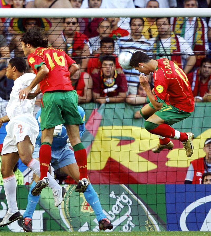 Portuguese forward Cristiano Ronaldo (R) heads the ball to score the opening goal, 30 June 2004 at the Alvalade stadium in Lisbon, during the Euro 2004 semi final football match between Portugal and The Netherlands at the European Nations  championship in Portugal. AFP PHOTO Lluis GENE (Photo by LLUIS GENE / AFP)