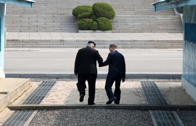 epaselect epa06695554 South Korean President Moon Jae-in (R) and North Korean leader Kim Jong-un (L) hold hands as they cross the military demarcation line (MDL) at the Joint Security Area (JSA) on the Demilitarized Zone (DMZ) in the border village of Panmunjom in Paju, South Korea, 27 April 2018. South Korean President Moon Jae-in and North Korean leader Kim Jong-un are meeting at the Peace House in Panmunjom for an inter-Korean summit. The event marks the first time a North Korean leader has crossed the border into South Korea sine the end of hostilities during the Korean War.  EPA/KOREA SUMMIT PRESS POOL / POOL