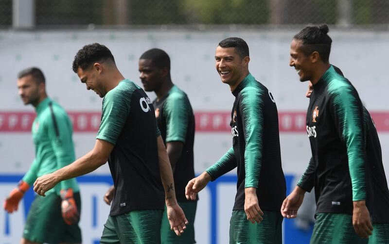 Cristiano Ronaldo, second right, laughs with teammates during a training session at their base camp in Kratovo, Moscow, Russia, on June 12, 2018. Francisco Leong / AFP