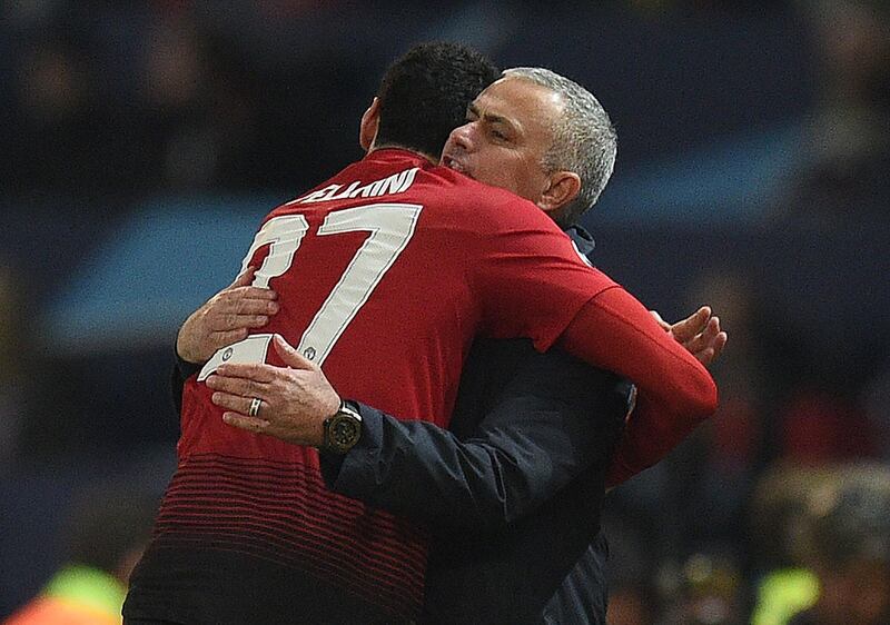 Manchester United's Marouane Fellaini celebrates with manager Jose Mourinho. AFP