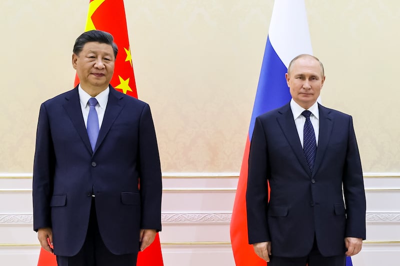 Mr Xi and Mr Putin pose for a photo on the sidelines of the summit. AP