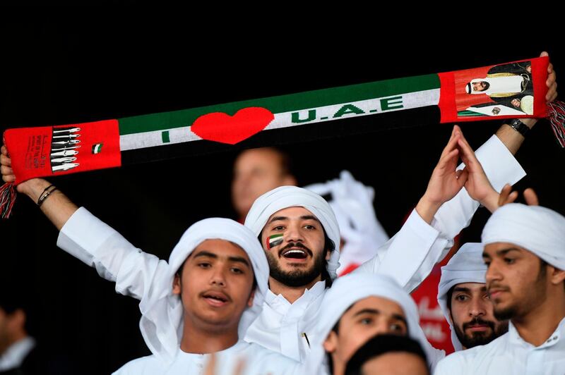 An Emirati supporter waves a scarf during the 2019 AFC Asian Cup group A football match between India and UAE at Zayed Sports City stadium in Abu Dhabi. AFP