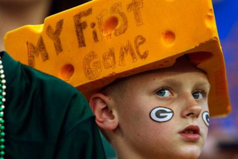 A young fan watches teams warm up before an NFL pre-season football game between the Green Bay Packers and the Kansas City Chiefs last week.