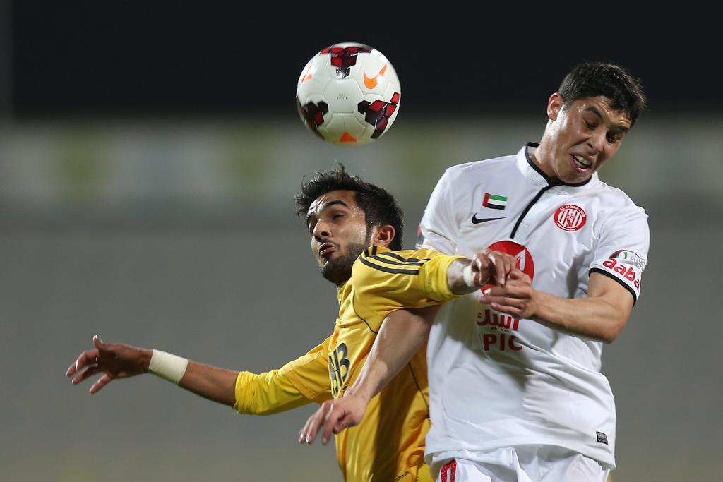 Al Jazira, in white, took advantage of league leaders' Al Ahli's draw against Al Wahda on Friday by beating Al Wasl to draw closer to the top of the Arabian Gulf League standings. Afsal Sham / Al Ittihad 