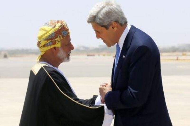 Omani foreign minister Yussef bin Alawi bin Abdullah (left) greets US secretary of state John Kerry as he arrives in Muscat.