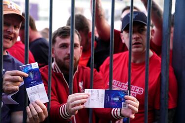 Liverpool fans stuck outside the ground show their match tickets during the UEFA Champions League Final at the Stade de France, Paris. Picture date: Saturday May 28, 2022.