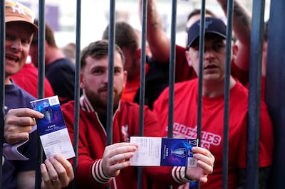 Liverpool fans stuck outside the Stade de France show their match tickets. PA