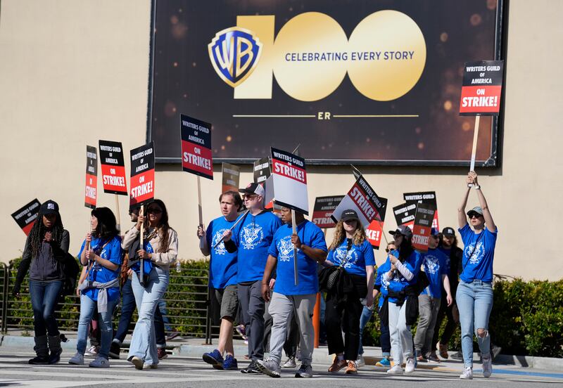 Members of the Writers Guild of America picket outside Warner Bros. Late-night shows are expected to stop production immediately, while television series and movies scheduled for release later this year and beyond could face major delays. AP Photo