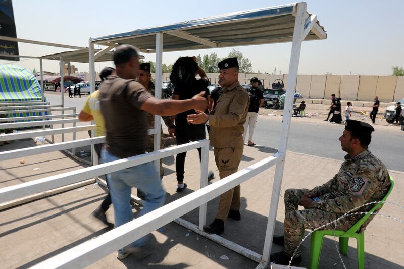 Iraqi policemen check Shiite pilgrims as they make their way to the tomb of Imam Hussain in Baghdad. EPA