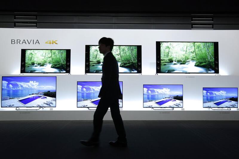 An attendant walks past Sony Bravia 4K LCD televisions displayed at a launch event in Tokyo, Japan. Kiyoshi Ota / Bloomberg