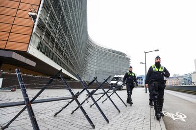 Belgian police officers patrol outside EU institution buildings protected by a barbed wire fence ahead of 'freedom convoy' protests on Monday. Photo: REUTERS/Yves Herman