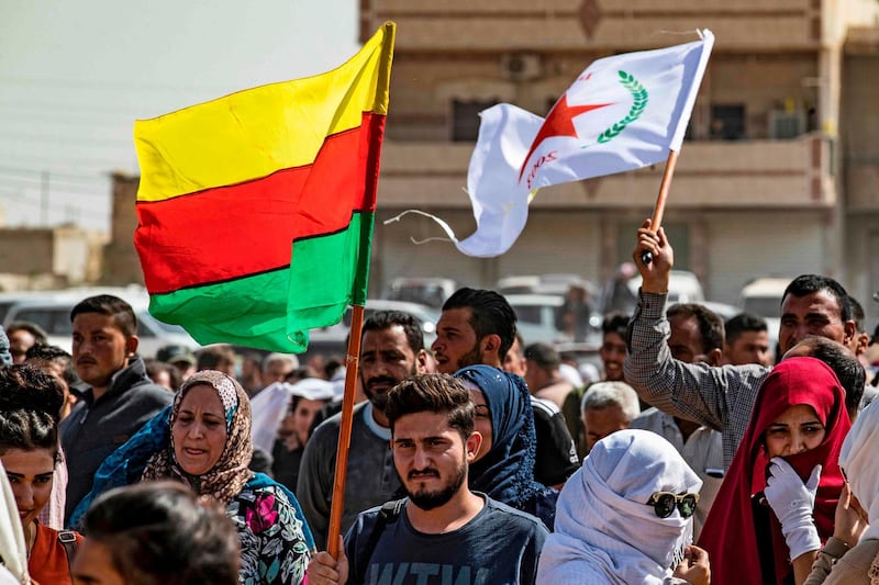 Syrian Kurds wave Kurdish flags. AFP