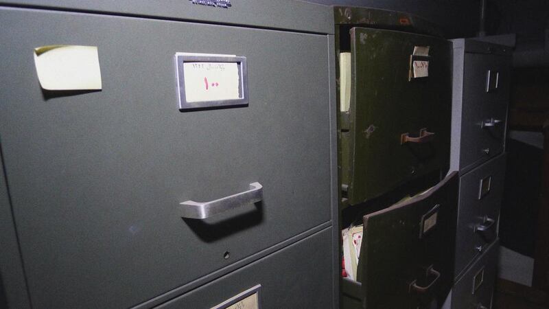 Bulging filing cabinets and old papers in the dank basement. Courtesy Ayyam Gallery