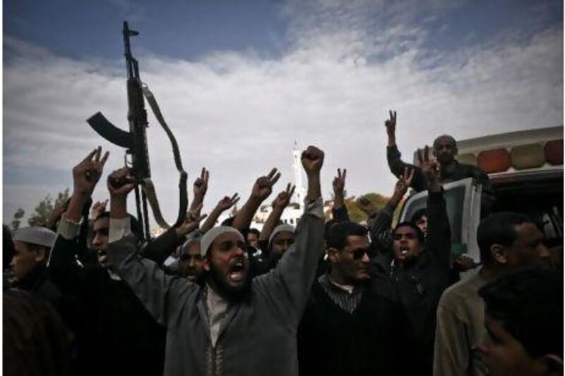 A crowd celebrates the expulsion of forces loyal to Muammar Qaddafi yesterday in Brega, Libya, a strategic oil port.