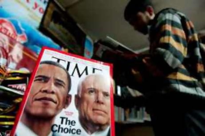 A Kashmiri customer looks through magazines featuring images of US Presidential candidates John McCain and Barack Obama on sale at a stall in Srinagar on November 4 2008. Americans vote in an election of rare historic potential, with front-running Democrat Barack Obama seeking to become the first black president and Republican John McCain hoping for a poll-defying comeback.  AFP PHOTO/TAUSEEF MUSTAFA *** Local Caption ***  629348-01-08.jpg
