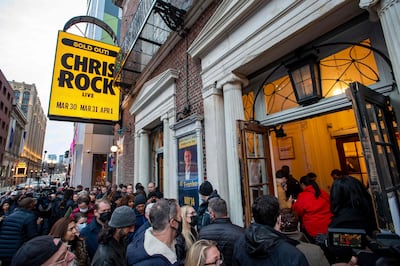 People wait in line to enter the Wilbur Theatre for a sold-out performance by Chris Rock. AFP