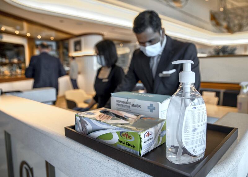 Abu Dhabi, United Arab Emirates, June 15, 2020.   
Viny gloves, face masks and hand sanitiser at the reception of the Cafe Milano at the Four Seasons Hotel, Abu Dhabi.
Victor Besa  / The National
Section:  If
Reporter:  Janice Rodrigues