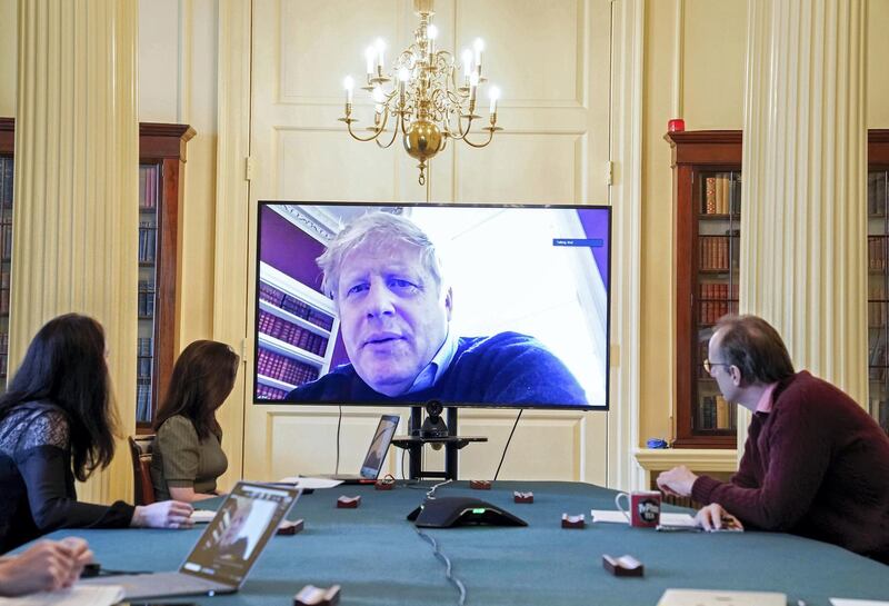 A handout picture released by 10 Downing Street, the office of the British prime minister on March 28, 2020, shows an image of Britain's Prime Minister Boris Johnson on a screen as he remotely chairs the morning novel coronavirus Covid-19 meeting by video link, in Downing Street in central London. - The two men leading Britain's fight against the coronavirus -- Prime Minister Boris Johnson and his Health Secretary Matt Hancock -- both announced Friday they had tested positive for COVID-19, as infection rates accelerated and daily death rate rose sharply. (Photo by Andrew PARSONS / 10 Downing Street / AFP) / RESTRICTED TO EDITORIAL USE - MANDATORY CREDIT "AFP PHOTO / 10 DOWNING STREET / ANDREW PARSONS / HANDOUT" - NO MARKETING - NO ADVERTISING CAMPAIGNS - DISTRIBUTED AS A SERVICE TO CLIENTS