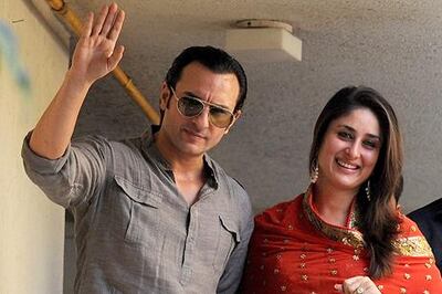 Newly-weds Saif Ali Khan and Kareena Kapoor wave to photographers in 2012. AFP