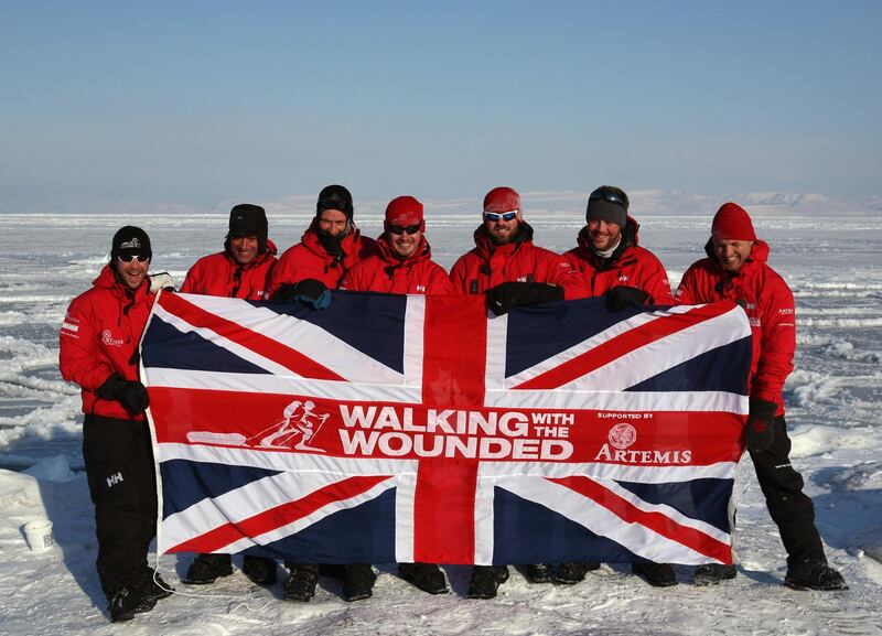 SPITSBERGEN, NORWAY - MARCH 31:  The Walking with the Wounded team trekking to the North Pole (L-R) Guy Disney, Simon Daglish, Edward Parker, Jaco Van Gass, Martin Hewitt, Steven Young and team leader Inge Solheim pose for a team photo as they train on the Norwegian Island of Spitsbergen on March 31, 2011 in Spitsbergen, Norway.   Harry is training before joining the group of wounded servicemen, for the first five days, trekking to the North Pole to raise money for the charity Walking With The Wounded of which he is patron.  Temperatures dropped as low as 25C last night in the camp in a valley near Longyearbyen as the team acclimatised to the extreme conditions, eating an evening meal out of freeze-dried packets and melting ice to drink and cook with.  (Photo by David Cheskin/WPA Pool/Getty Images)