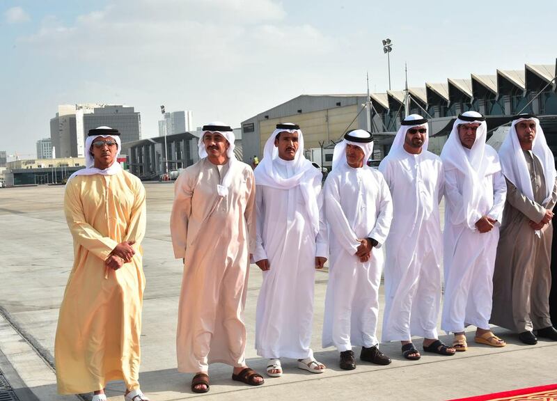 Sheikh Mansour bin Zayed, Deputy Prime Minister and Minister of Presidential Affairs, and Sheikh Abdullah bin Zayed, Minister of Foreign Affairs, greet the bodies of the men as they arrive back on UAE soil. Wam