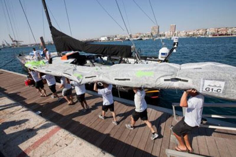 Members of the Abu Dhabi Ocean Racing team carry a mainsail ahead of their training day in Alicante, Spain. The team put together comprises several nationalities, including two Emirati sailors.