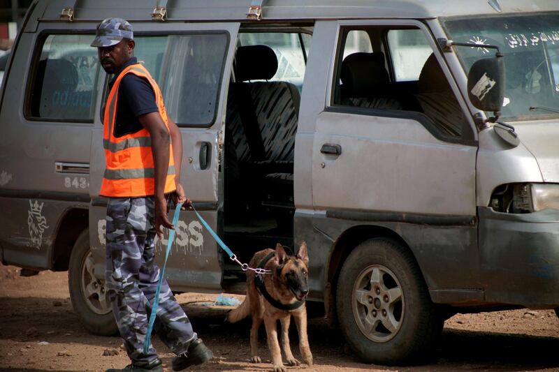 A Sudanese soldier with sniffer dog secure the area outside the courthouse, where former Sudanese president Omar al-Bashir and more than 20 others are tried for their role in the 1989 military takeover of the government, Khartoum, Sudan.  EPA