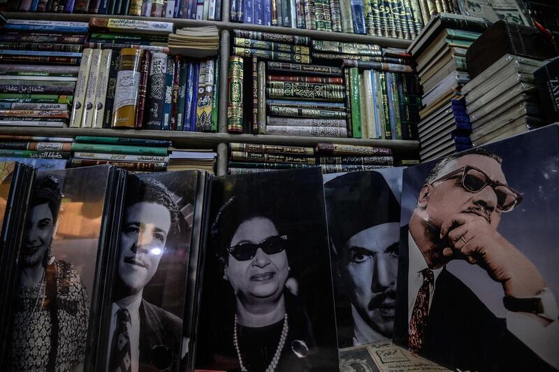 Posters of famous Egyptian singers, actors and politicians are seen on sale at Cairo's historic Al Azbakeya book market at central in Cairo. AFP