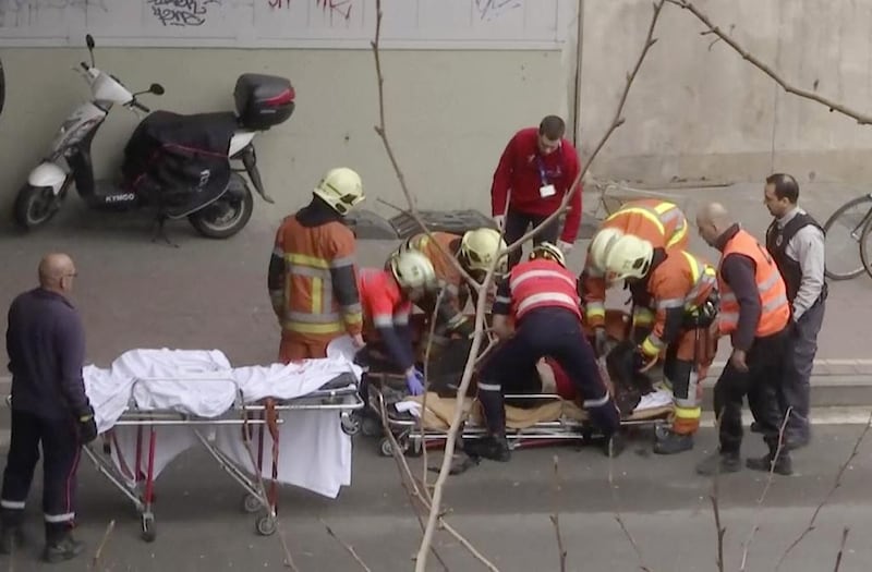 In this image made from video, emergency rescue workers attend to a victim of an explosion at a metro station in Brussels, Belgium, on March 22, 2016.   Explosions rocked the Brussels airport and the subway system Tuesday, just days after the main suspect in the November Paris attacks was arrested in the city, police said. APTN via AP