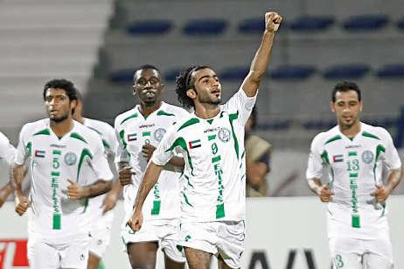 Adnan al Beloshi, centre, celebrates after opening the scoring as Emirate defeated Al Wahda 3-1 to win the Super Cup last night.