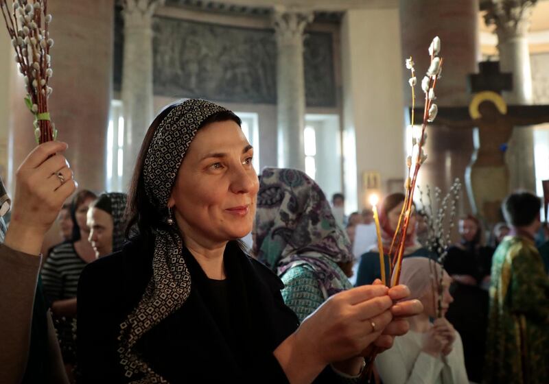 Russian Orthodox Church believers hold willow branches, while celebrating Palm Sunday in Moscow. EPA