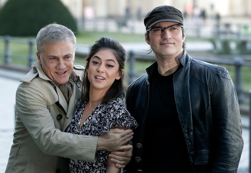 Actor Christoph Walz, left, hugs actress Rosa Salazar, center as they pose for photographers with director Robert Rodriguez, right, during a photocall for the movie 'Alita: Battle Angel' in Berlin, Germany, Wednesday, Jan. 30, 2019. (AP Photo/Michael Sohn)