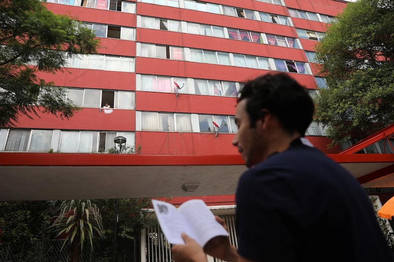 Mexican architect Percibald Garcia reads aloud a different story from a book everyday to children stuck at home in an apartment complex in the Tlatelolco neighbourhood in Mexico City, Mexico. Reuters