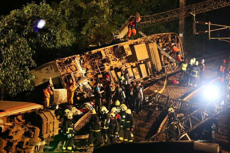Rescue workers work at the site where a train derailed in Yilan county, Taiwan. REUTERS