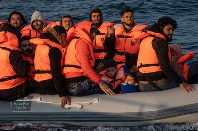 An inflatable craft carrying migrant men, women and children crosses the shipping lane in the English Channel in July off the coast of Dover, England. Getty Images