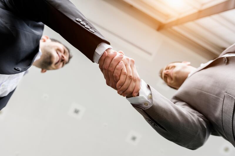 Businessmen shaking hands. Getty Images