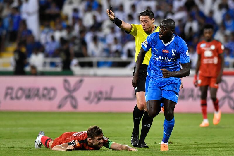 Al Ettifaq player Jordan Henderson, left, is tackled by Al Hilal's Kalidou Koulibaly, right, during their Saudi Pro League match. EPA