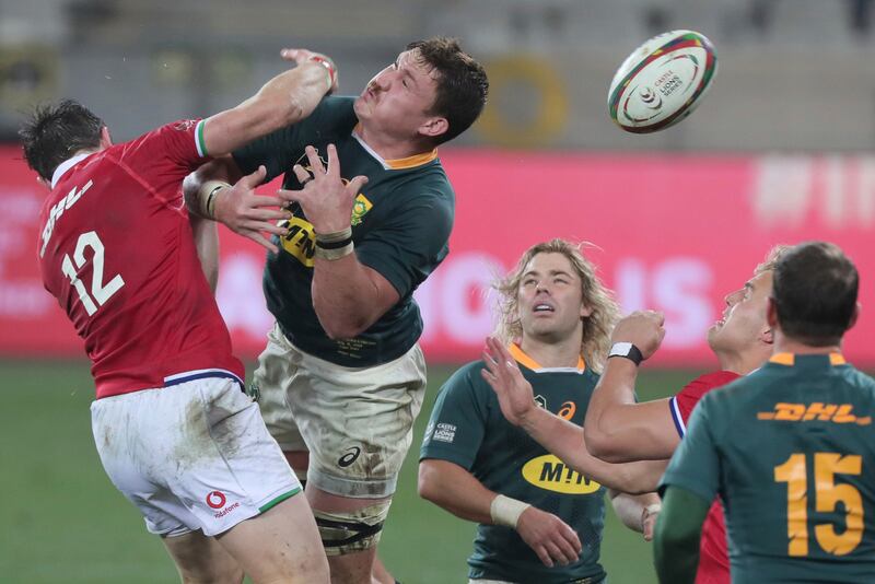 British & Irish Lions' Robbie Henshaw, left and South Africa's Jasper Wiese attempt to catch a loose ball.
