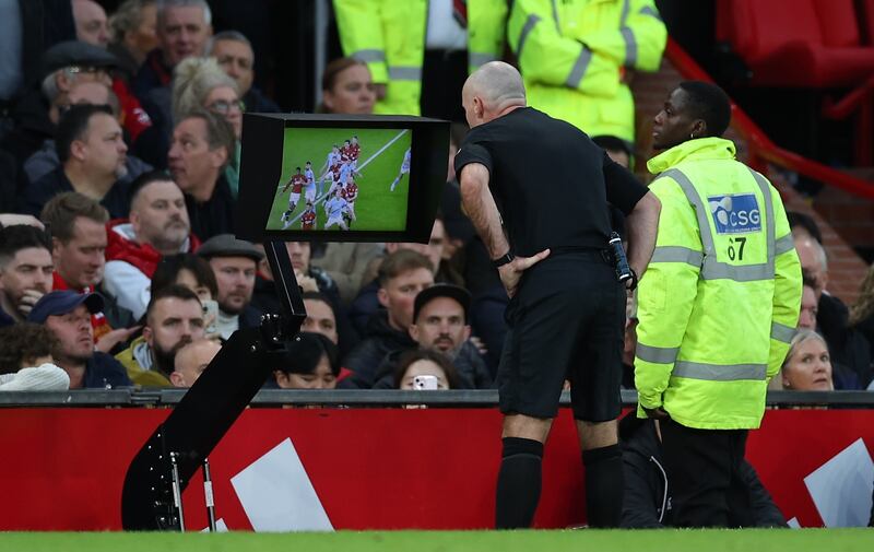 Referee Paul Tierney checks the VAR display before awarding a penalty for Manchester City. EPA