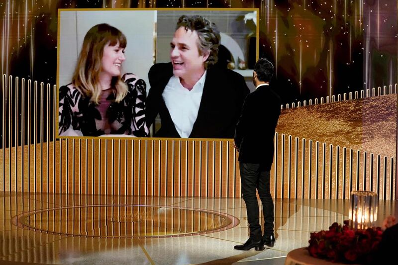 Mark Ruffalo, alongside Sunrise Coigney, accepts the Best Actor - Television Motion Picture award for 'I Know This Much Is True' via video as Justin Theroux stands onstage at the 78th Annual Golden Globe Awards. AFP / NBCUniversal