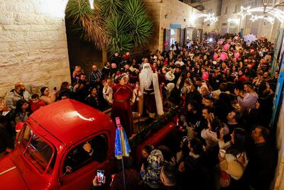 Palestinians dressed as Santa Claus and Mrs.Claus n Bethlehem, in the Israeli-occupied West Bank. Reuters