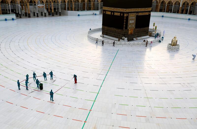 Workers clean around the Kaaba, traced with lines for physical distancing, at the Grand Mosque in Makkah, Saudi Arabia. AFP